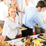 A catered office party is full of jolly employees.